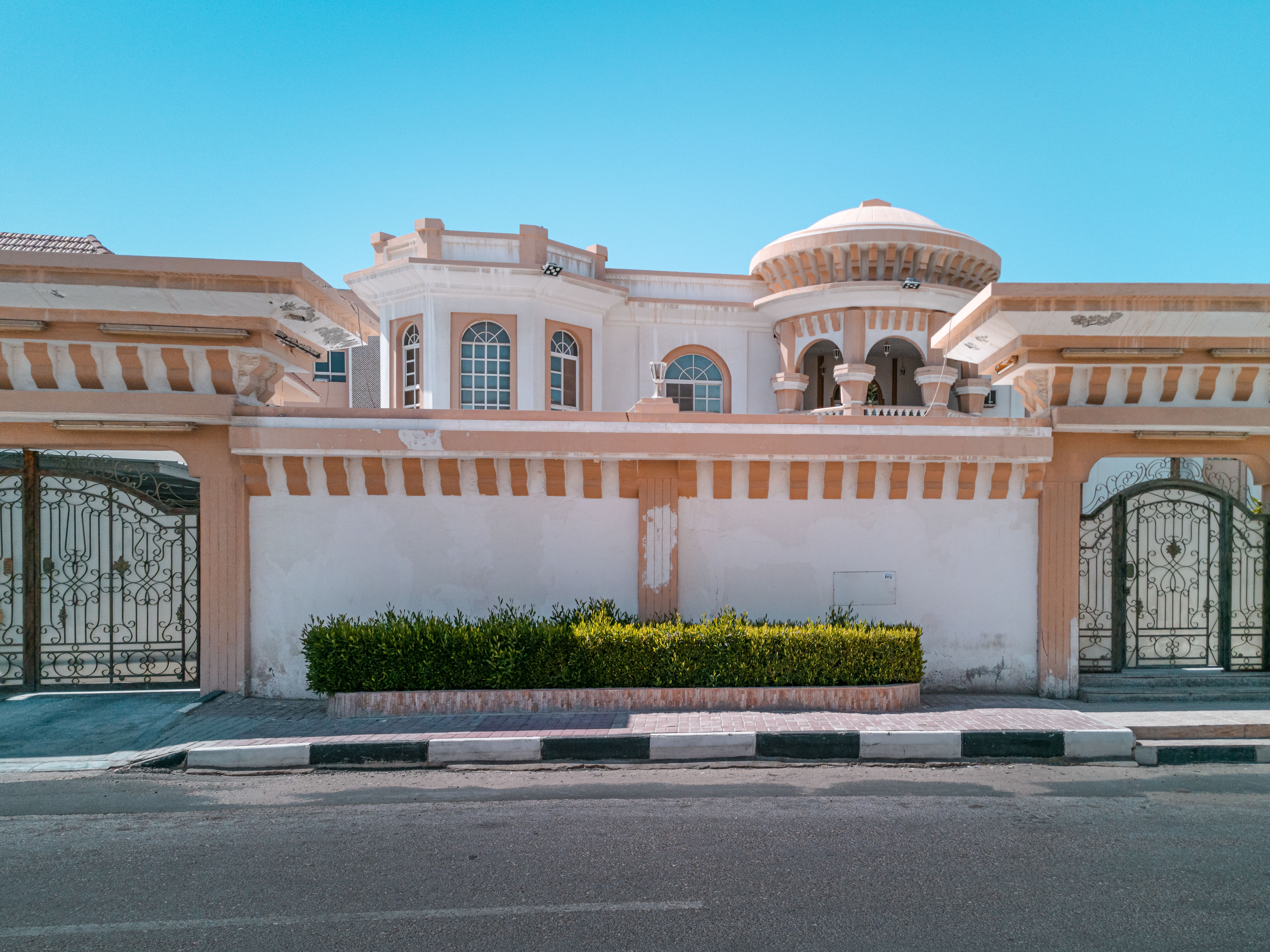 Villa exterior in Dubai showing peeling paint and wall damage before repainting
